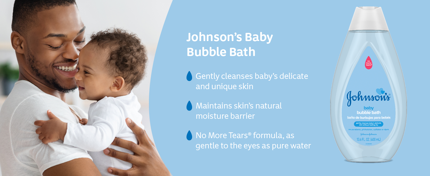 Smiling father holds baby after bathtime with Johnson's Baby Bubble Bath